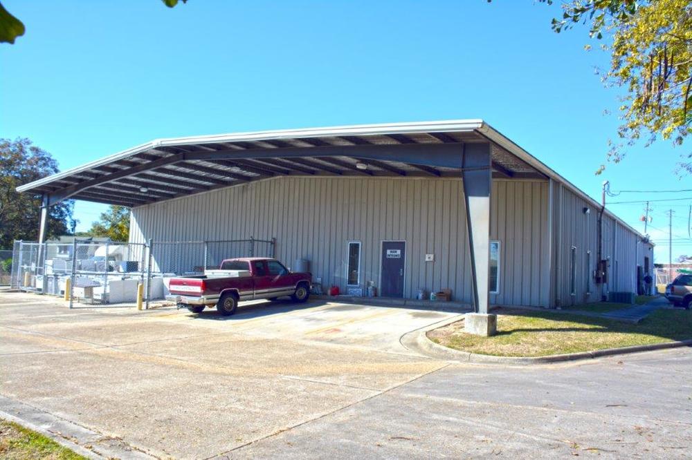 large metal maintenance building with truck sitting in front